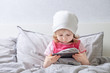 © tremasov_sergei - Baby plays smartphone on the bed