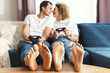 © blackday - Young happy couple playing video game console