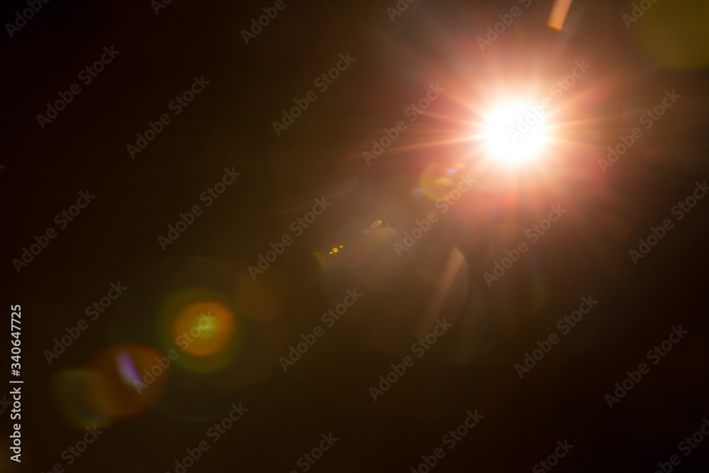 Abstract Natural Sun flare on the black background. - obrazy, fototapety, plakaty 