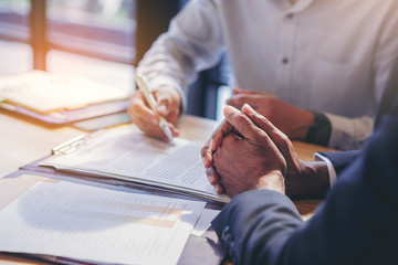 businessman reading documents at meeting, business partner considering contract terms before signing