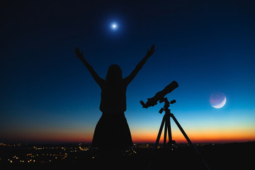 Wall Mural - silhouette of a woman and telescope with twilight sky.