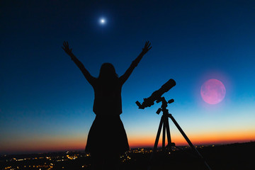 Wall Mural - silhouette of a woman and telescope with twilight sky.