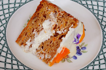 Wall Mural - Vegan carrot cake with candied carrot ribbons and fresh violet flowers