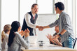 © Shutter B - Successful agreement negotiation in business meeting concept. Businessman and asian partnership handshake after finish meeting with happy enjoy laugh smile and great success emotion.