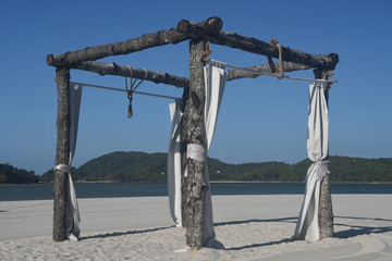 Canvas Print - Romantic place on Langkawi beach. Awnings from the sun and wind with white fabrics on white sandy beach Pantai Cenang. Vacation and holidays on Andaman sea Islands, Malaysia.