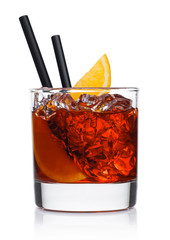 Negroni Cocktail in modern glass with ice cubes and orange slices with straw on white background with reflection.