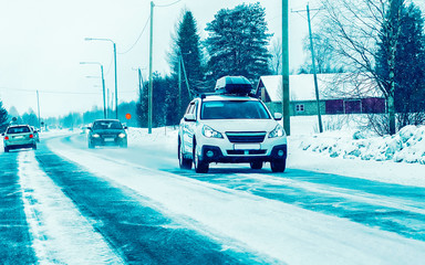 Wall Mural - Car with roof luggage rack  on road of Finland reflex