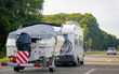 Caravan with trailer for motor boats road in Switzerland reflex