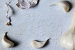© ElenaIvanova - Fresh cloves of garlic, dry garlic skin on the stone background. Flat lay frame pattern, copy space. Close- up, top view