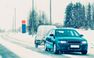 Canvas Print - Car with trailer in road in Rovaniemi winter Lapland Finland reflex