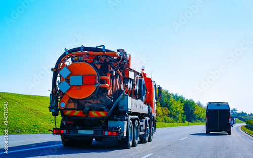 Vacuum waste truck on highway road in Slovenia reflex