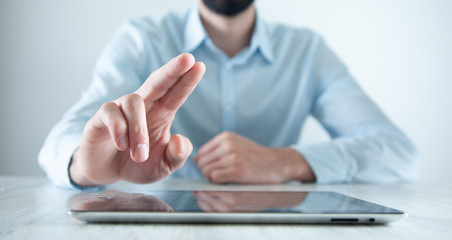 Wall Mural - man hand tablet with finger in screen