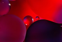 Vertical Graphic Illustration Of Red, Black And Purple Circles On A Red Background