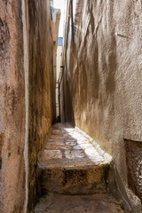 Wall Mural - Old town narrow pedestrian walkway between street building walls in Altamura, Apulia, Italy