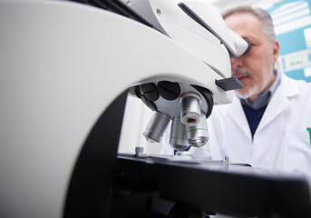 Poster - Man using microscope in laboratory, coronavirus medical research concept