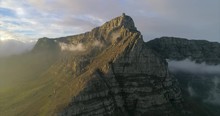 Aerial Shot Of An Astounding Mountain Among Clouds Under Blue Sky, Drone Flying Backwards - Cape Town, South Africa