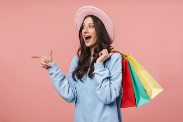 Sticker - Image of young woman pointing finger while holding shopping bags