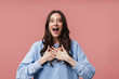 © Drobot Dean - Image of young woman screaming in delight and holding hands at her chest