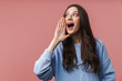 © Drobot Dean - Image of young woman screaming or calling with hands at her mouth