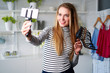 © artiemedvedev - Fashion blogger woman in jeans and turtleneck showing high heel shoes on camera. Stylist influencer girl showing trendy footwear filming vlog episode for her channel. Opinion leader sets trends.
