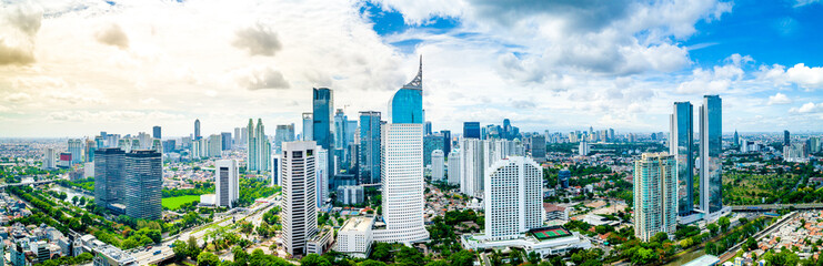 Aerial View of Jakarta Downtown Skyline with High-Rise Buildings With White Clouds and Blue Sky, Indonesia, Asia