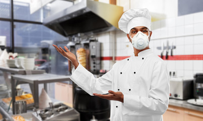 health protection, safety and pandemic concept - indian male chef cook wearing face protective mask or respirator over kebab shop kitchen background