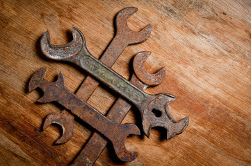 Old vintage spanners of the last century extracted from the chest in the workshop of grandfather. Background for craftsmanship and manual labor.