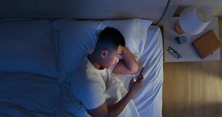 Canvas Print - man use smartphone on bed