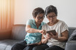 geing society concept, Asian elderly senior adult women sisters using mobile digital tablet smart phone application for social media network among friends community via internet communication