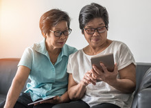 Geing Society Concept, Asian Elderly Senior Adult Women Sisters Using Mobile Digital Tablet Smart Phone Application For Social Media Network Among Friends Community Via Internet Communication