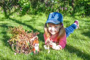 cute little girl with flowers in the forest