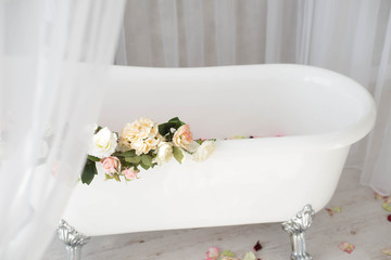 White bath with rose petals