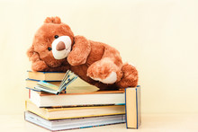 Toy Bear Reading An Interesting Book, Showing That Even Read Toys. The Concept Of Baby Learning