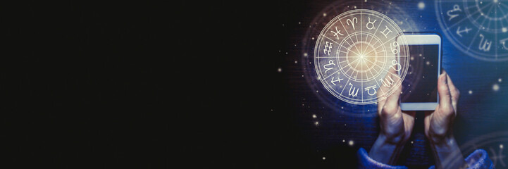 Wall Mural - female hands are holding a phone and an astrological circle with the familiar zodiac against a starr