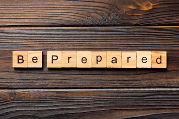 BE PREPARED word written on wood block. BE PREPARED text on wooden table for your desing, concept