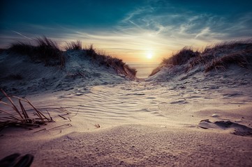 Fototapeta Breathtaking shot of a beautiful beach on a wonderful sunset background