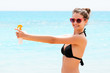 © sosiukin - Young woman with sun protection spray for body at the beach