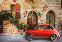 Old Vintage Italian Scene. Small Antique Red Car. Fiat 500. Old Italian House With Outside A Small Subcompact Old Nostalgia Red Car, Fiat 500. Vintage Scene. Assisi, Italy.