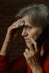 Wall Mural - Portrait of ill senior woman calling doctor