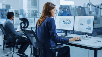 Poster - Over the Shoulder: Team of Mechanical Engineer Working on Personal Computers, Screens Shows CAD Software with 3D Prototype of Electric Engine, Turbine. Industrial Factory with High-Tech CNC Machinery