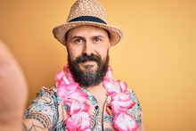 Handsome Bald Man With Beard And Tattoo On Vacation Wearing Summer Hat And Hawaiian Lei With A Happy Face Standing And Smiling With A Confident Smile Showing Teeth