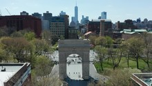 Sunny Day Flying Over Arch And Tilting Down On Washington Square Park In NYC