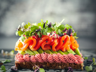 Wall Mural - Gourmet  sandwich  with smoked salmon,avocado, beet hummus and sprouts.