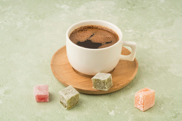 Colorful Turkish delights and coffee on green with copy space