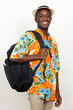 Portrait of happy young African tourist man with backpack ready for vacation