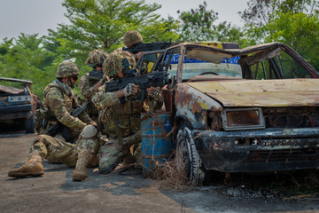 Special Forces soldier in combat uniforms aiming gun rifle to attack enemy, Concept war, army, weapon, technology protection