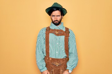 Wall Mural - Young handsome man wearing tratidional german octoberfest custome for Germany festival skeptic and nervous, frowning upset because of problem. Negative person.