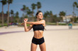 © F8  \ Suport Ukraine - Morning workout. Warming up before training. Young fit woman in sportswear doing hand stretching on the beach at sunrise