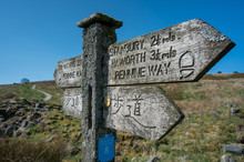 A Footpath Sign In English And Japanese Giving Directions To Top Withens Haworth Or Withins