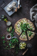 © Patricia Garcia/ADDICTIVE STOCK - From above top view of pizza with greenery slices of squash on table with spices olive oil cheese for vegetarian dinner